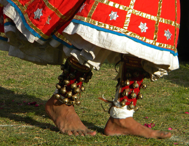 Male dancers with red whirling skirts and bells on their ankles at the Jaipur Elephant Festival