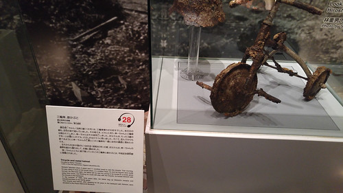 Partly melted tricycle and helmet of small child killed by Hiroshima WWII Atomic Bomb blast