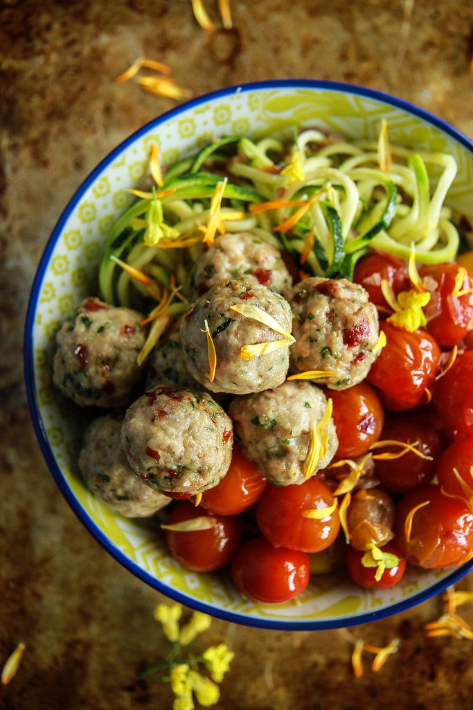 Zoodles with blistered tomatoes and mini sundried tomato chicken meatballs- paleo from HeatherChristo.com