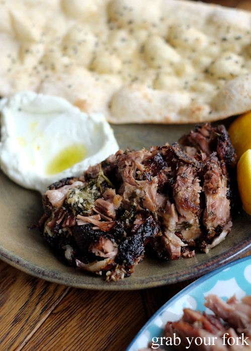 Lamb shoulder with garlic, lemon and pita bread at Barzaari Cypriot and Greek restaurant in Marrickville