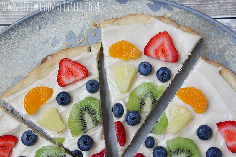 This fruit pizza is so easy and so yummy! The best way to eat fruit! A layer of soft sugar cookie, topped with cream cheese frosting, and colorful fruit! The perfect dessert for your next party!