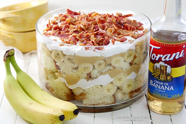Elvis Trifle with Bacon in a glass bowl with bananas and a bottle of Torani Banana Creme.